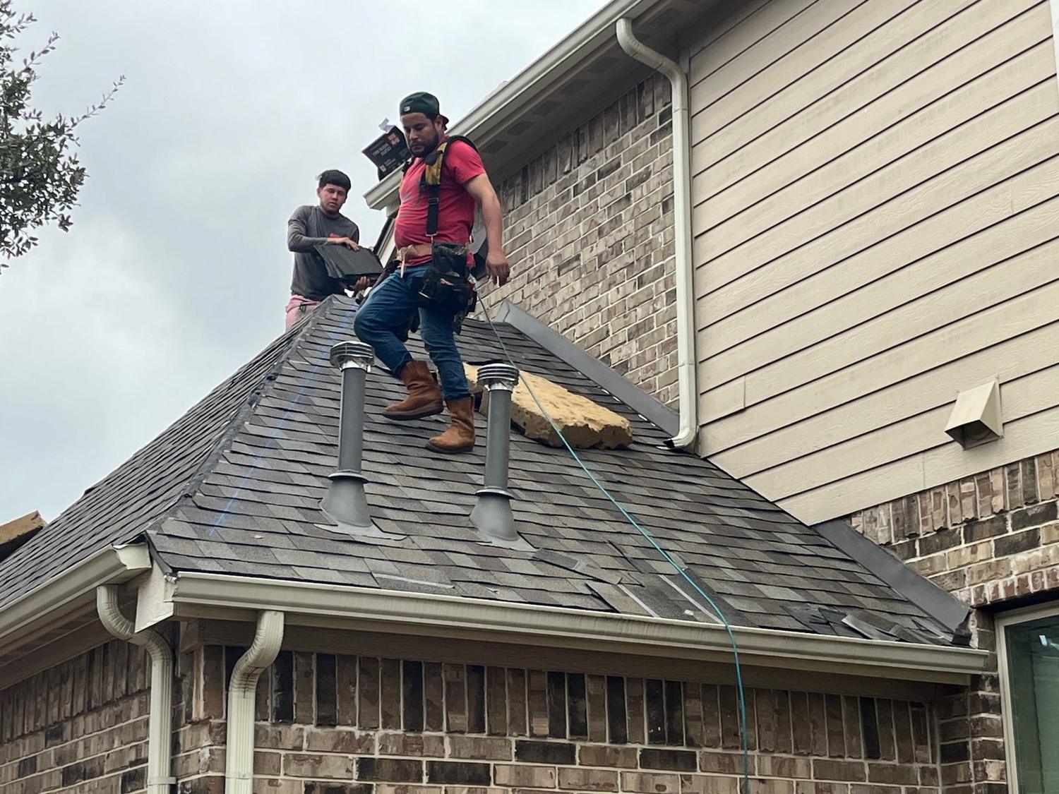 Burrage crew repairing shingles around roof vents